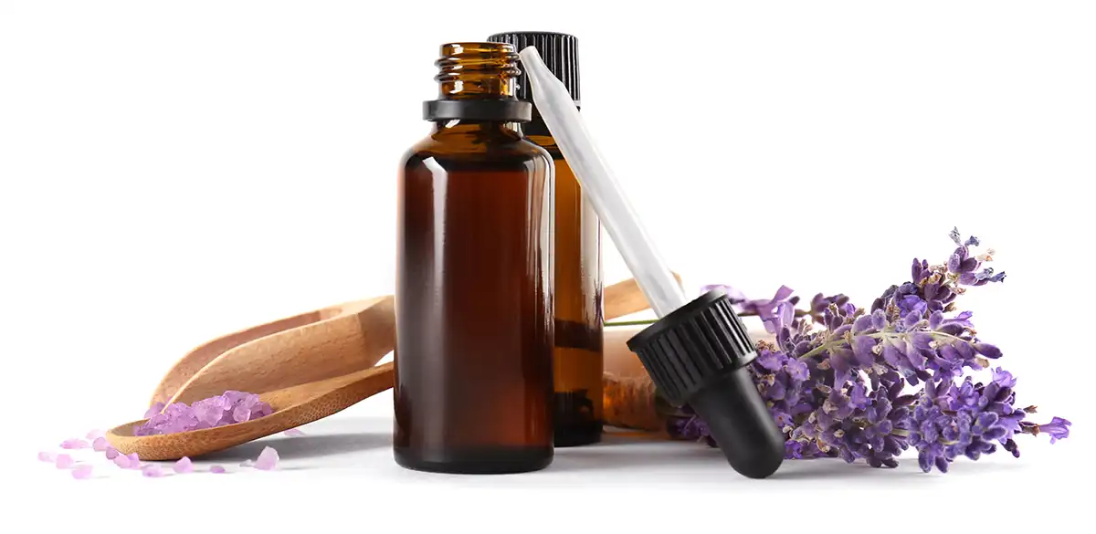 Bottles of Essential Oils for Aromatherapy Surrounded by Lavender
